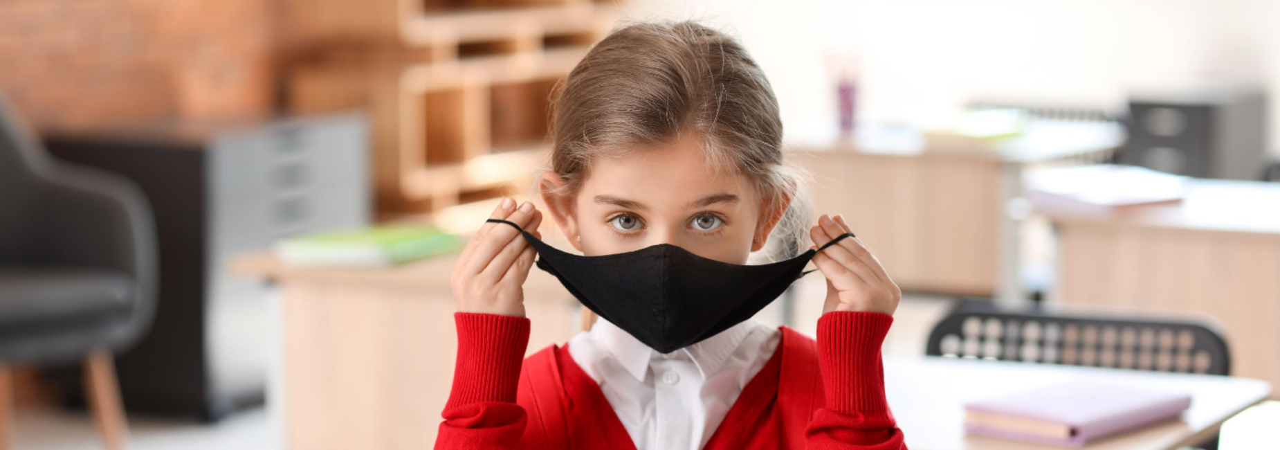 girl putting on mask