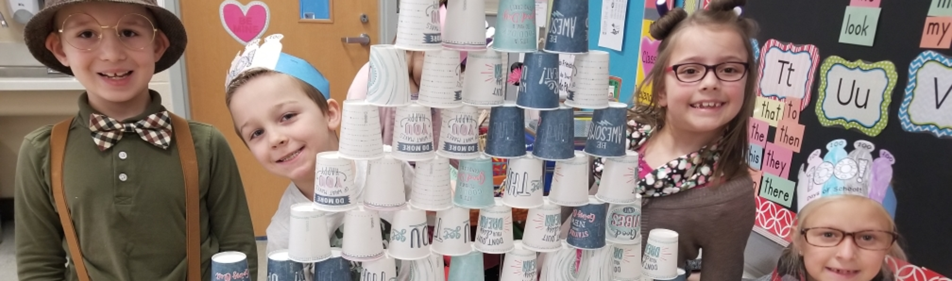 Students in Mrs. Weyandt's 1st grade classroom stack 100 cups to celebrate the 100th day of school.