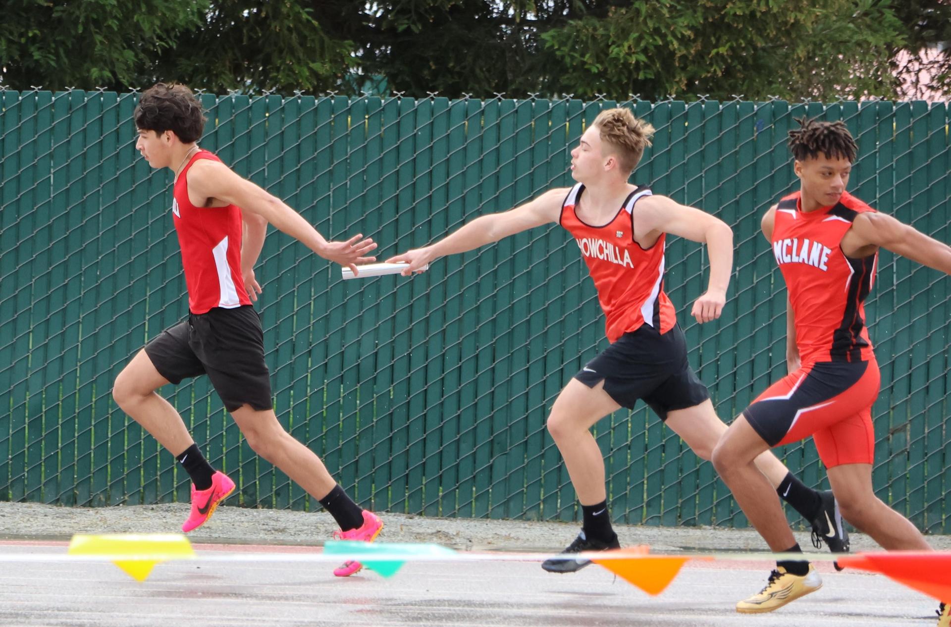 junior varsity boys running the four by 100 meter relay