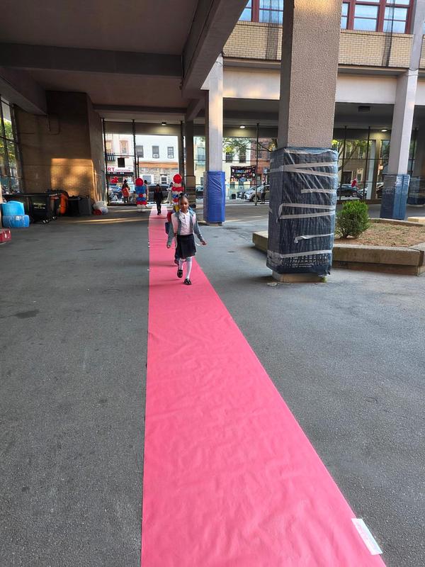 Students walking on a red carpet for their return