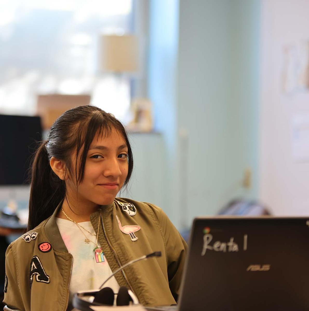 Student working on a computer in a classroom.