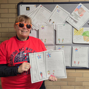 Police officier holds up letters from Noble Columbus students