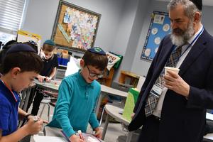 A grandfather watches his grandkids learn.