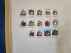 Coloring contest entries hanging on a wall.