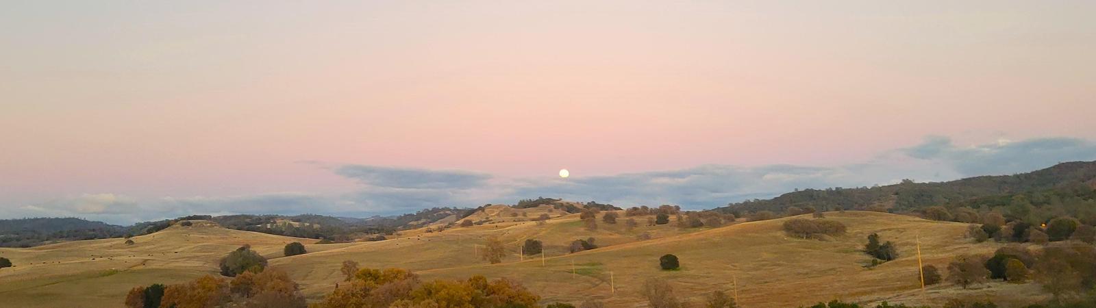 moon rise over dry hillside
