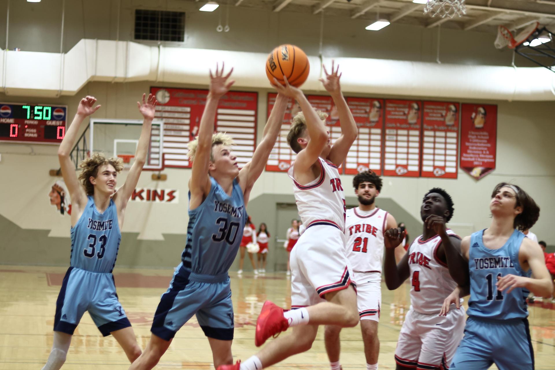 Varsity boys playing basketball against yosemite