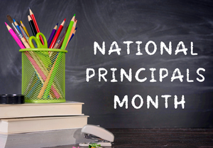 office material and a chalkboard that reads school principals month