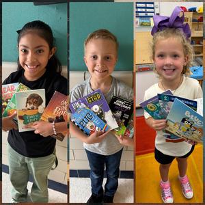 Two girls and one boy holding books