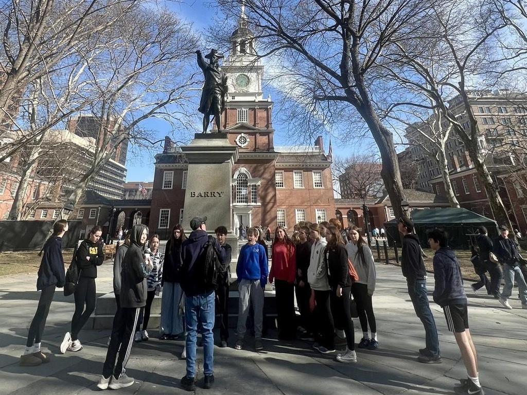 Students standing in front of the Commodore Barry statue at the Independence Center in Philadelphia.