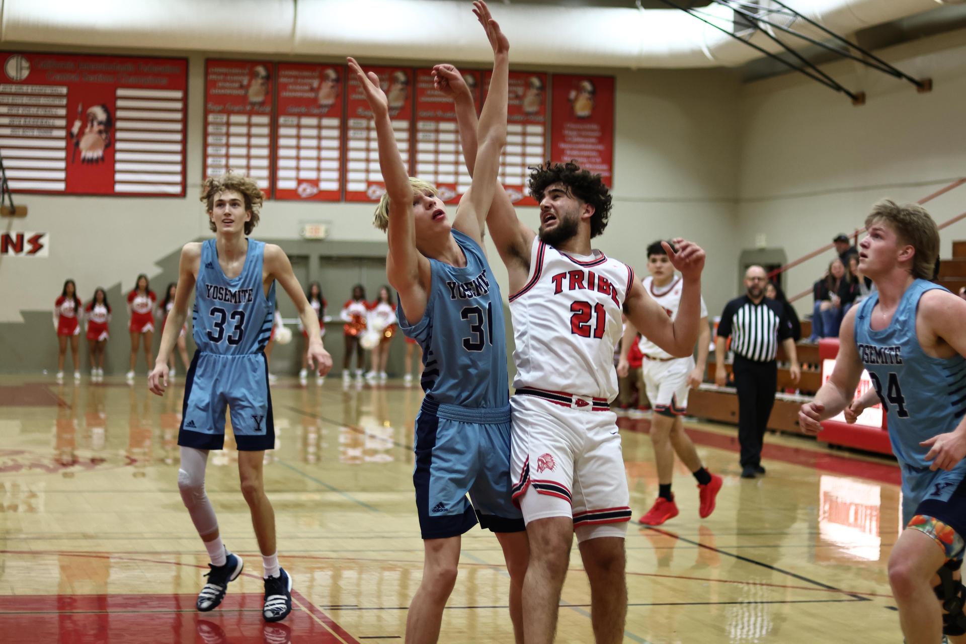 Varsity boys playing basketball against yosemite