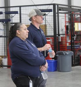 Aviation Maintentance Technology instructors Erica Malonado and Mike McIntyre listen to Superintendent Martin's remarks