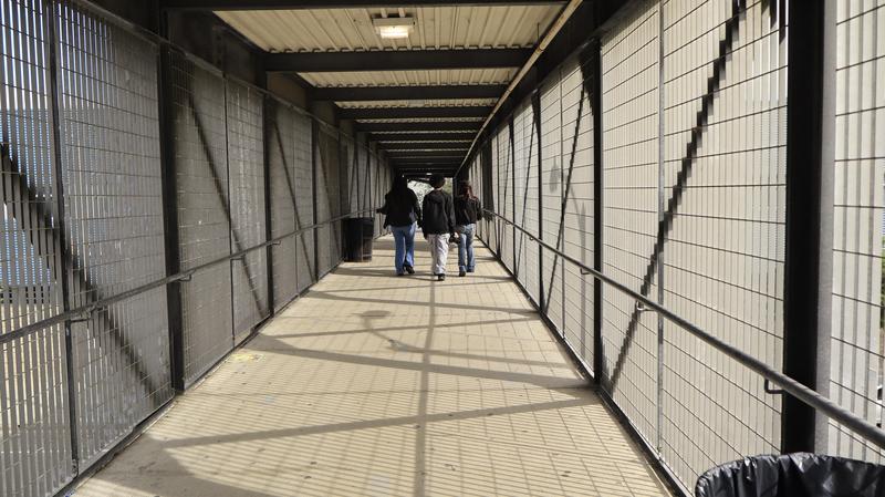 3 students walking down the Clinton bridge