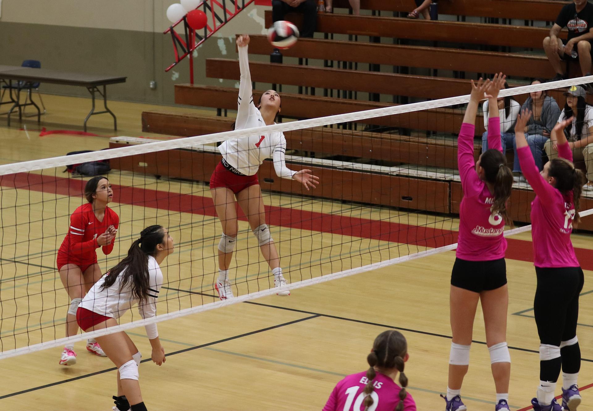 varsity volleyball players in action against Minarets