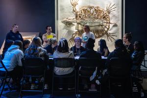 Students discuss around a table