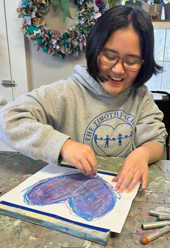 Student painting heart.