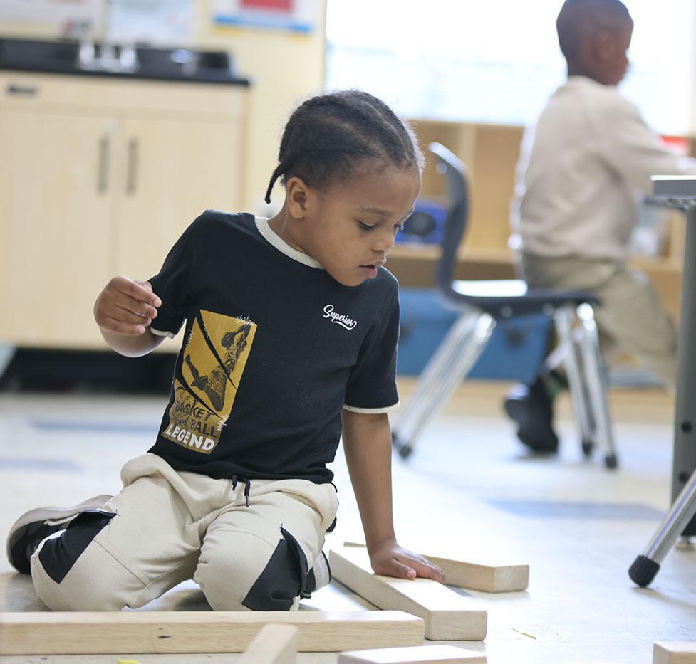 MIMMSAD student playing with blocks in the classroom