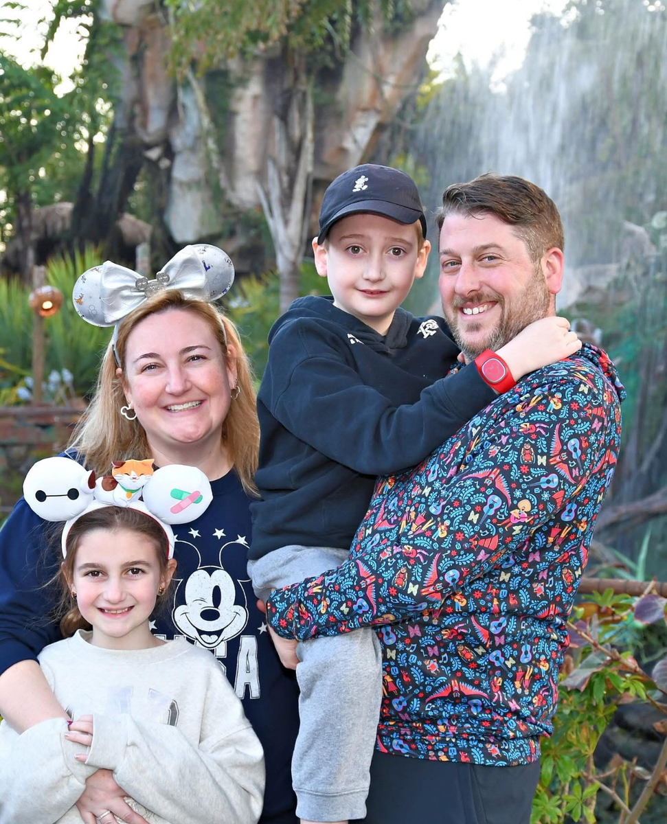 family photo, outdoors, husband, wife, and two small children