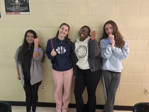 Students showing off their glow in the dark bracelets