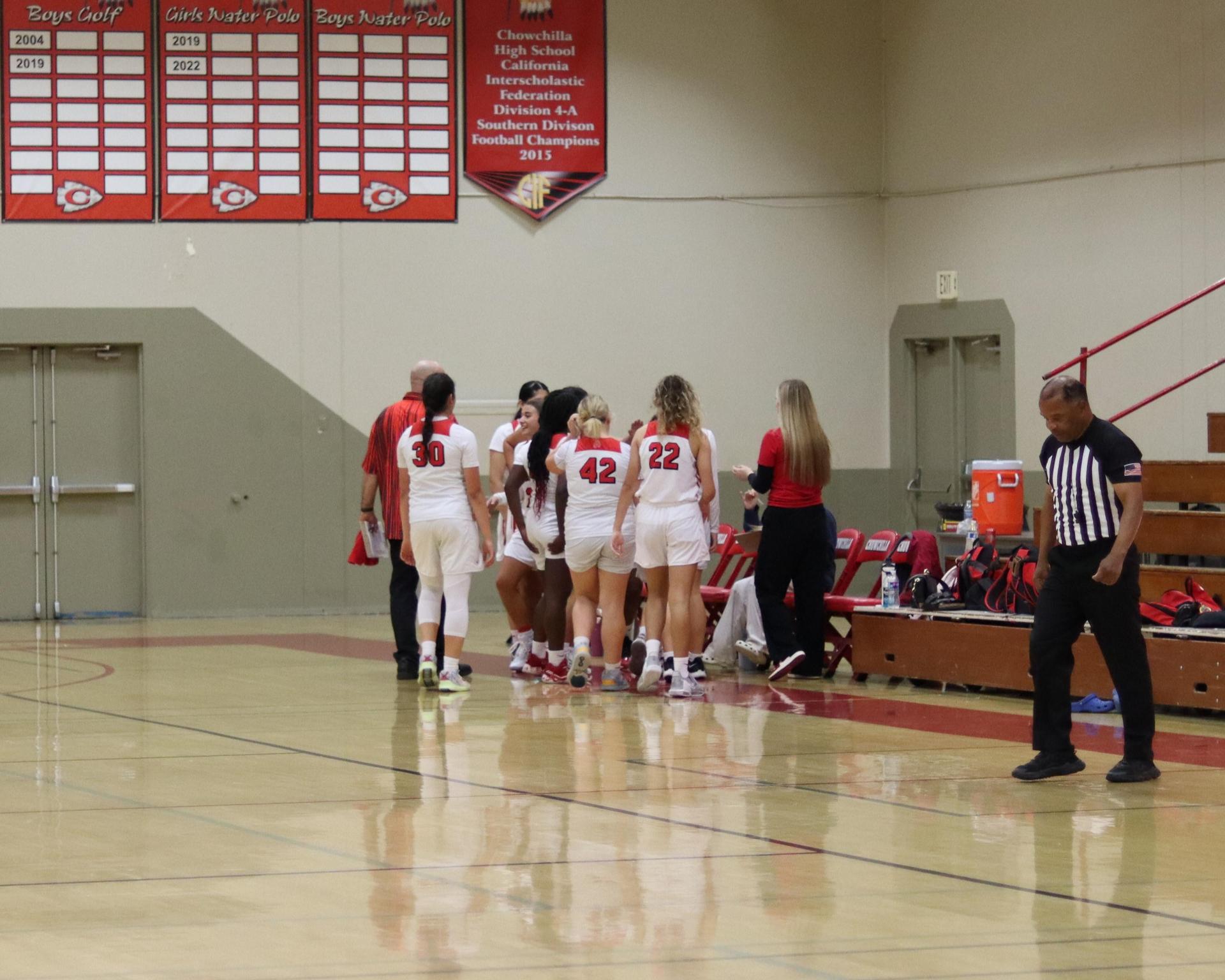 varsity girls playing basketball against mclane