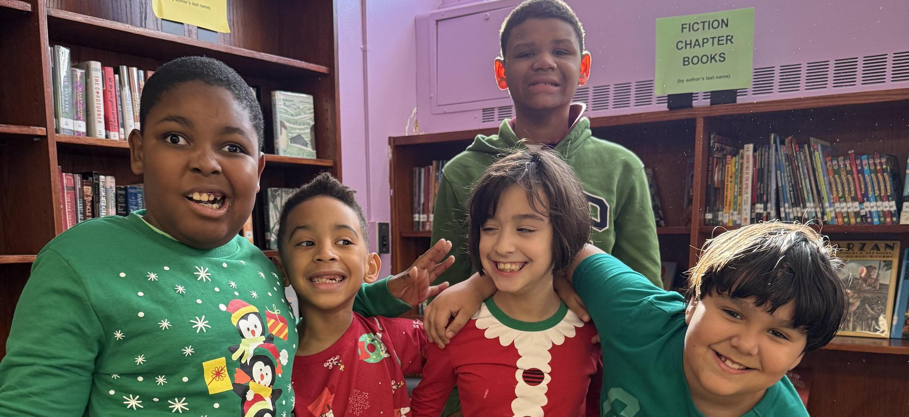 Four students posing on Ugly Sweater Day.