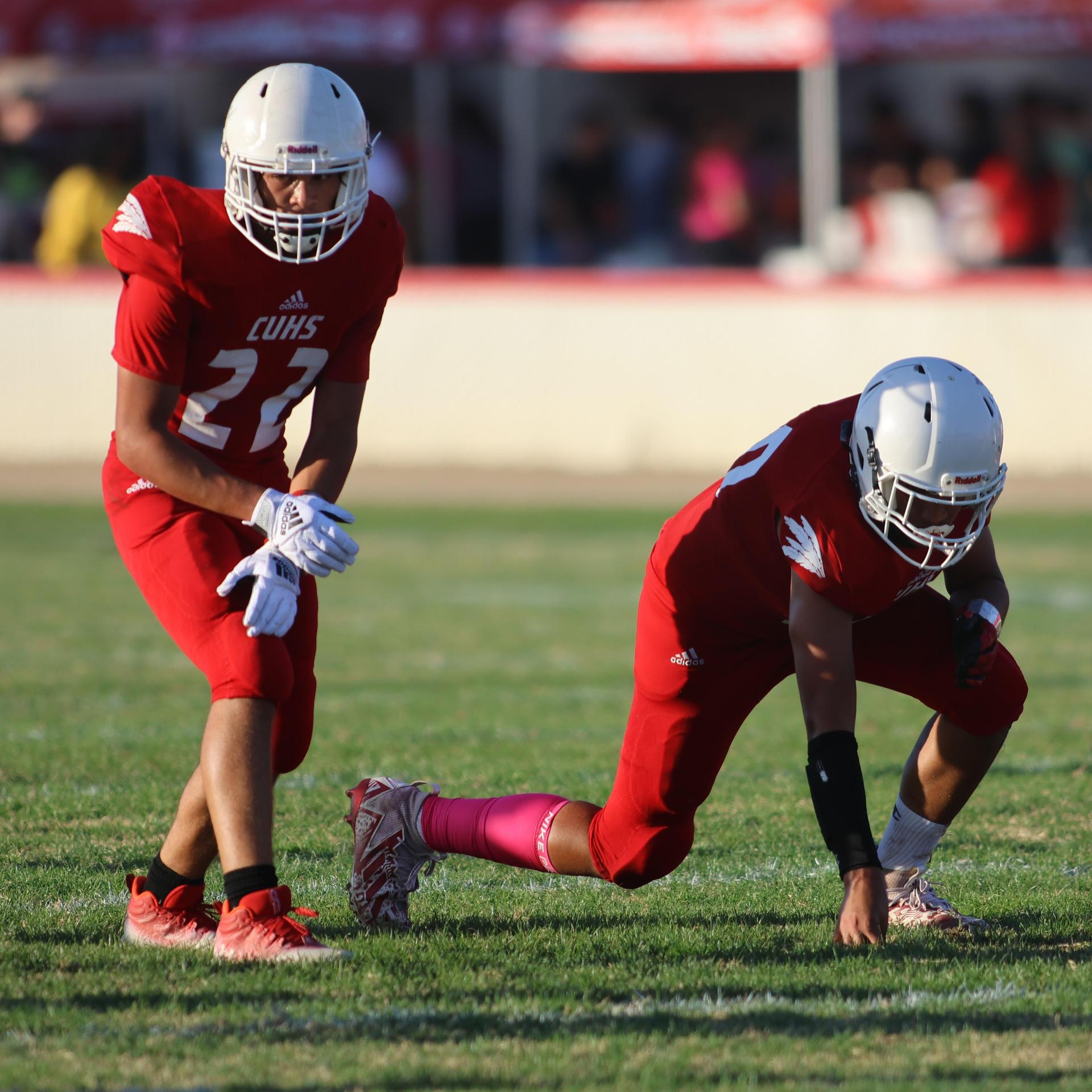 junior varsity football players in action against Fowler