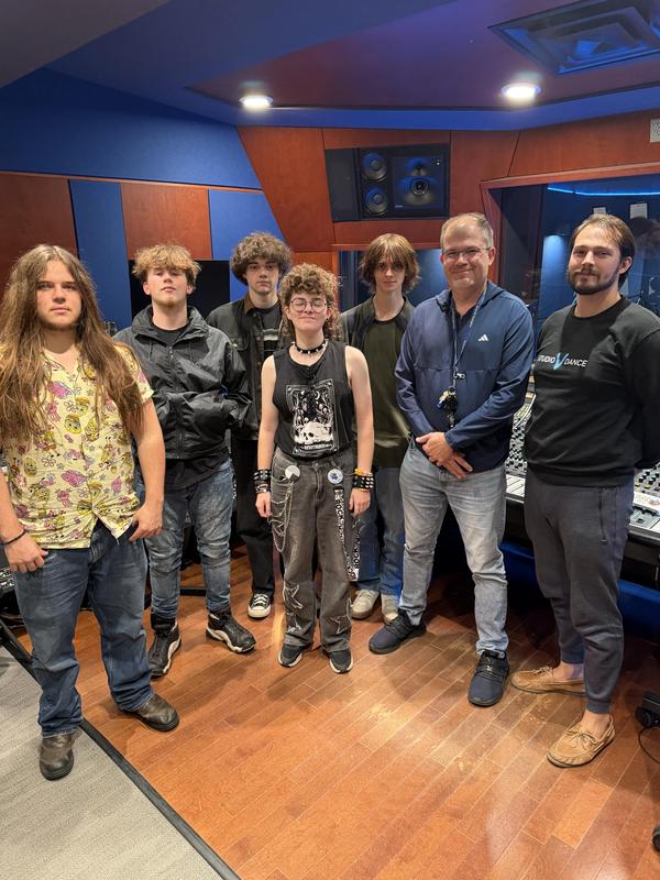 teacher and students standing in record studio