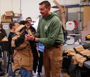 student trying on bomb suit