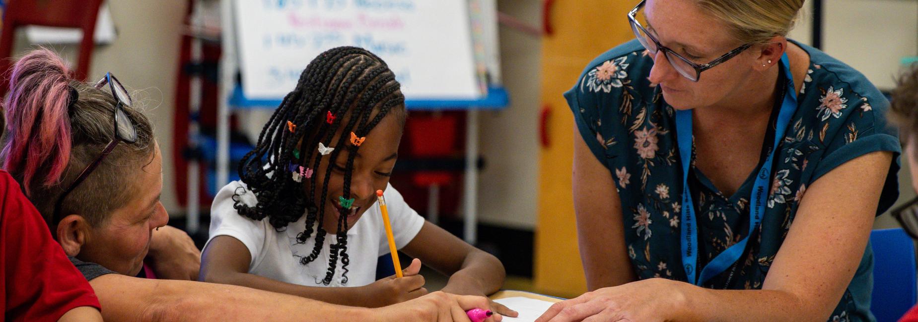 Elementary faculty work with a student