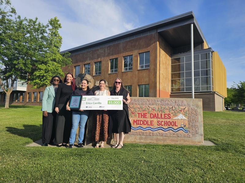 Staff with Awards in front of School Sign