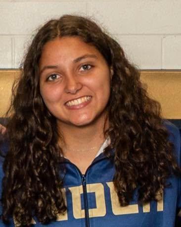 girl wrestler smiling with long curly hair
