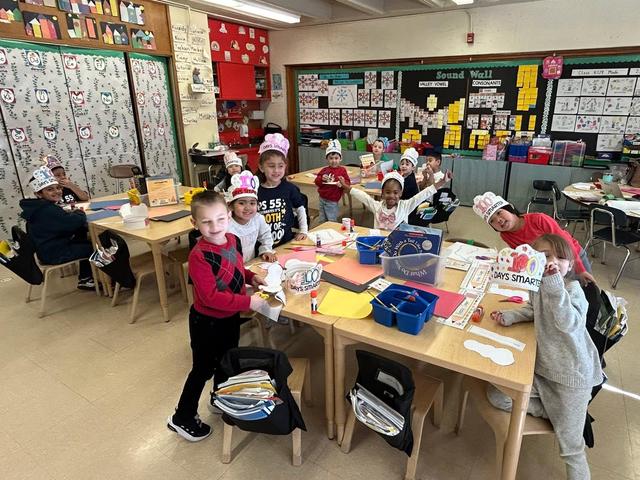 Students in a classroom engaged in an arts and crafts activity.