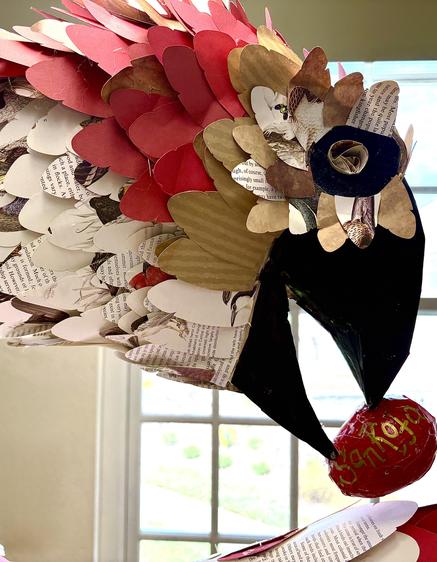 Colorful paper sculpture resembling a bird with intricate details.