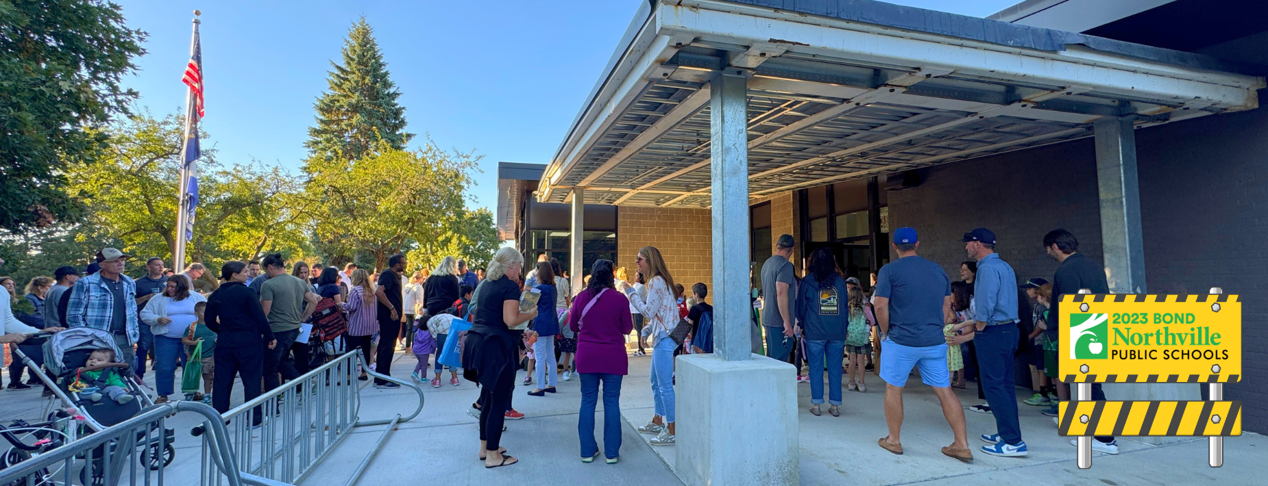 New canopy overhang at Amerman Elementary with a bunch of parents standing under it on the first day of school.