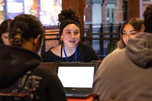 A student smiles as they share a thought