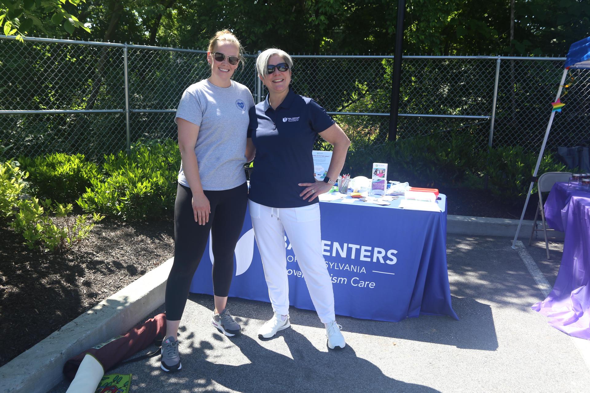 Two women standing at ABA of PA table.