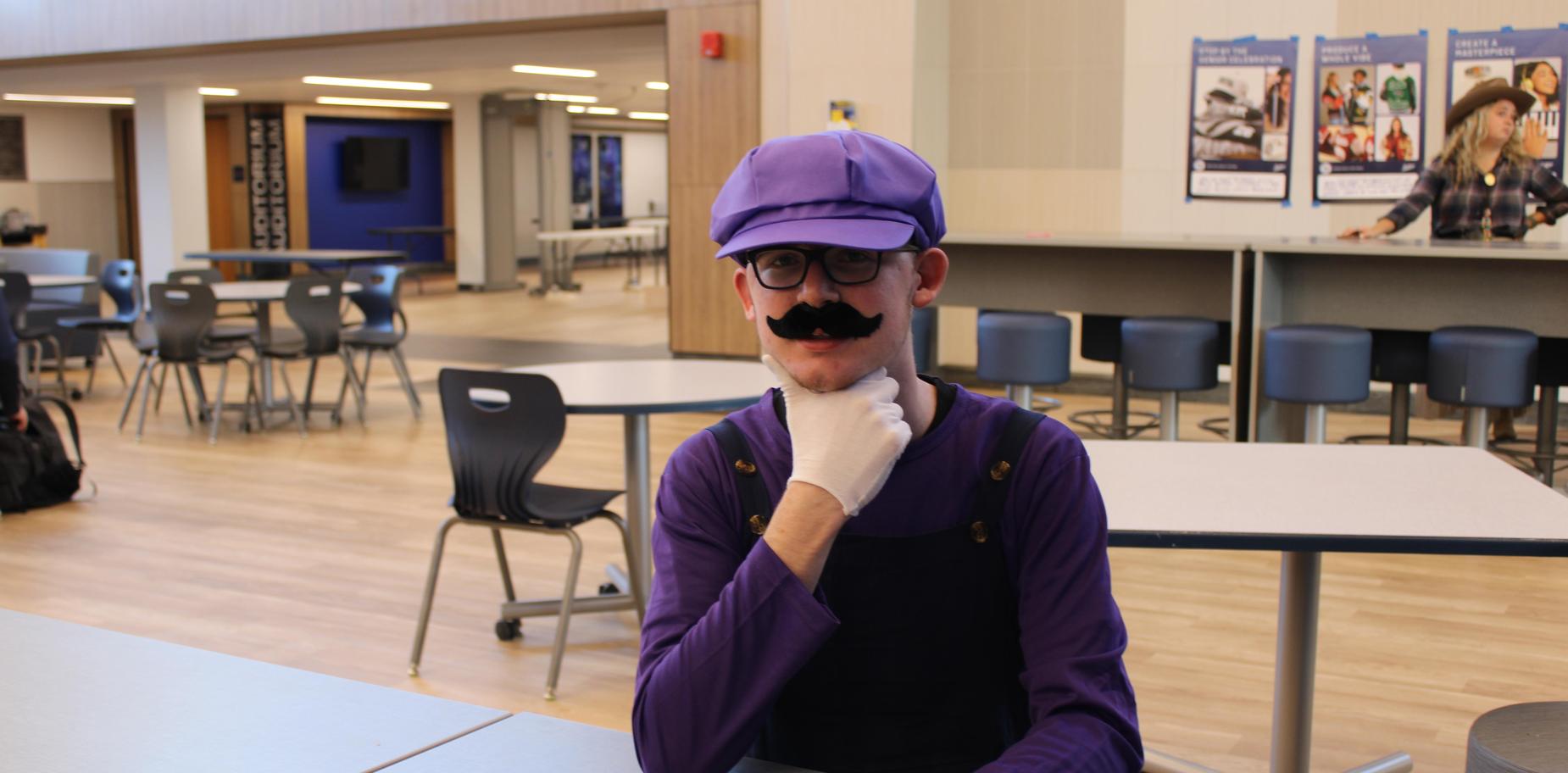 Student in a Mario Kart costume sitting at a table.