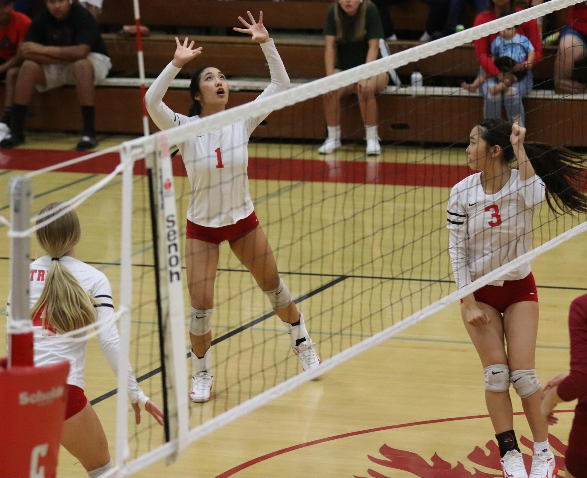 varsity volleyball players in action against golden valley