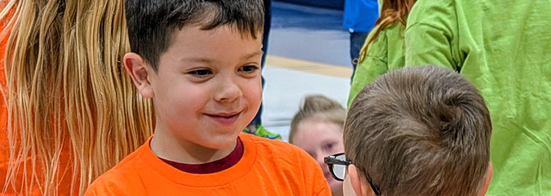 Boy smiles at another student
