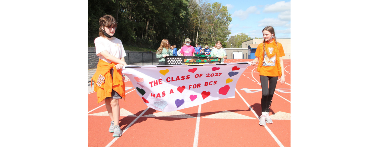 students carrying a banner