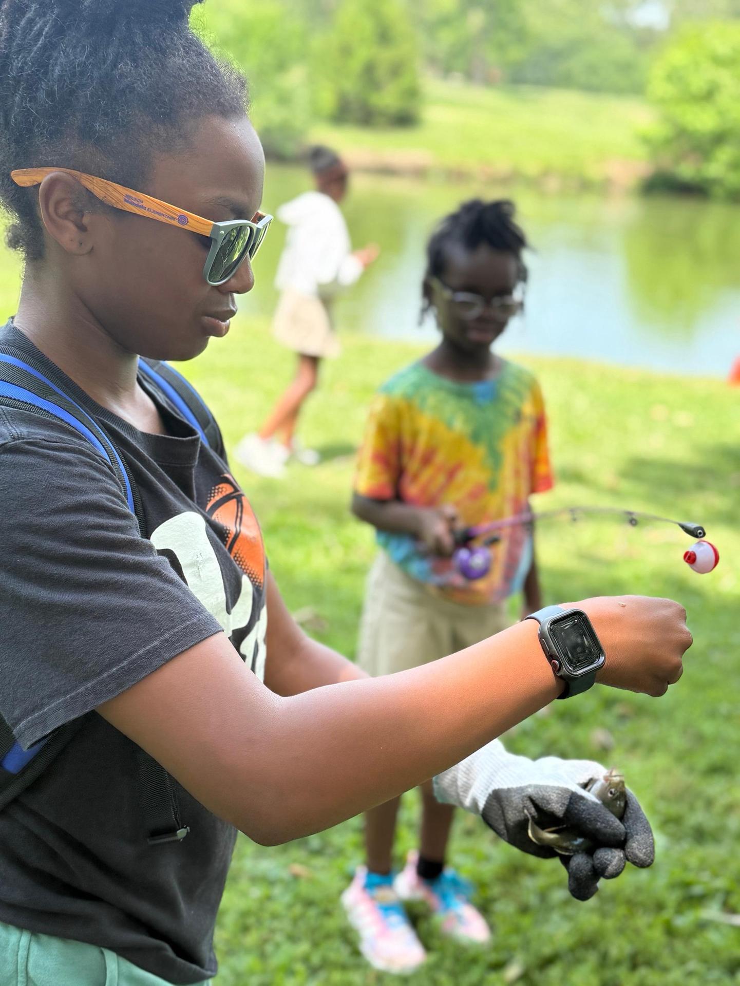  Helping take a fish off the hook.