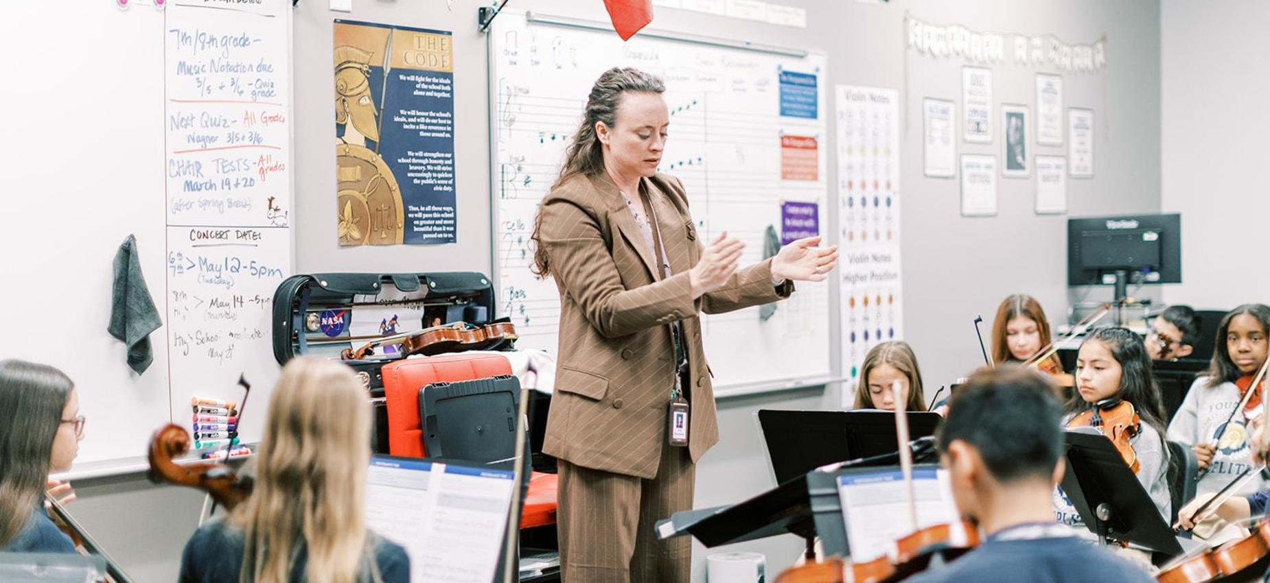Teacher leads a string orchestra class