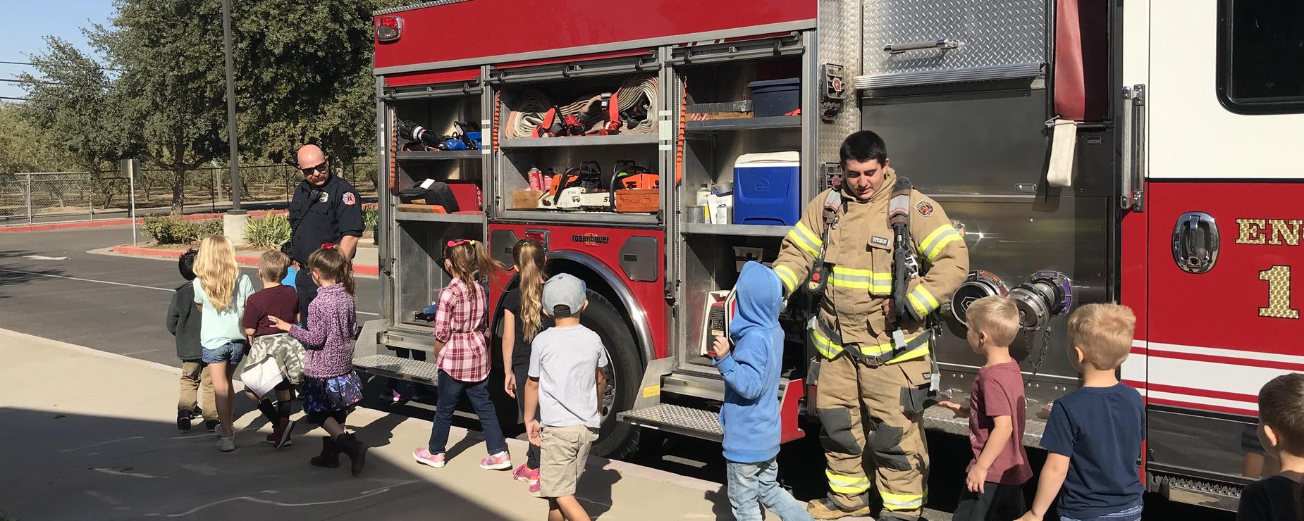 Firefighter high fives kindergarteners