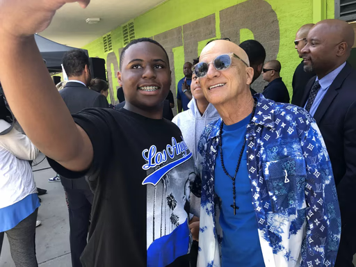Ninth-grader Jaylen Bell, left, takes a selfie Thursday with music industry mogul Jimmy Iovine, who co-founded a new public high school in South L.A. with rap artist Andre “Dr. Dre” Young. (Howard Blume/Los Angeles Times)