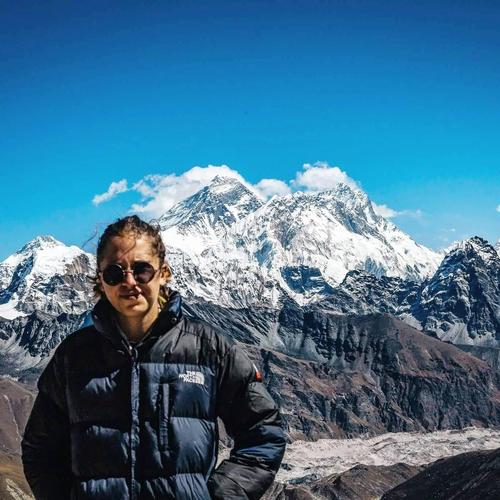I love to be outside. This is a picture of me with Mount Everest in the background!