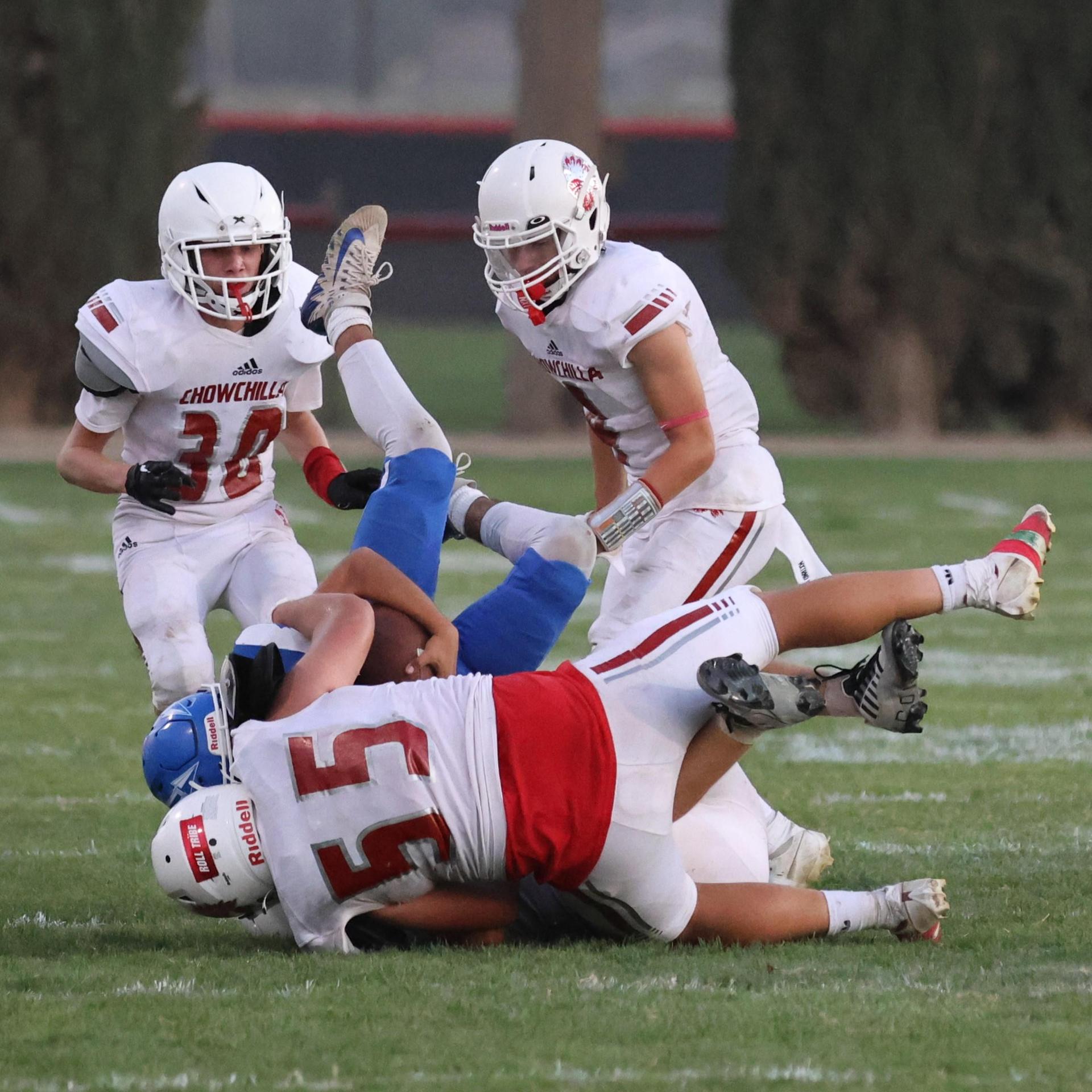 Junior Varsity football players in action against Caruthers