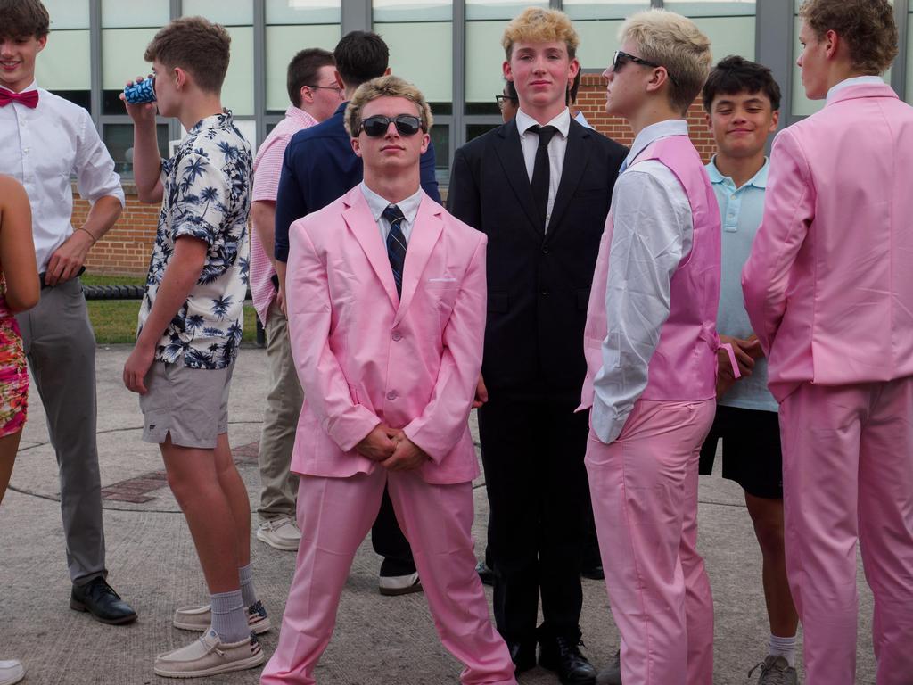 Students in pink suits and sunglasses.