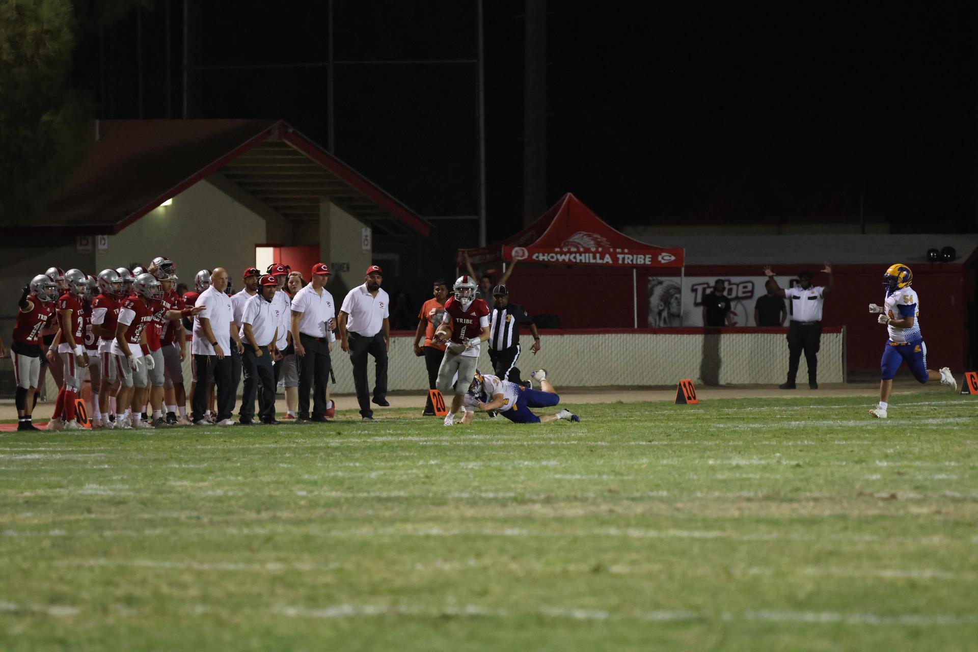 Varsity football players in action against Parlier 46