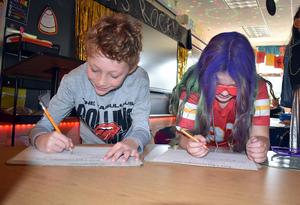 Students completing reading and math activities.