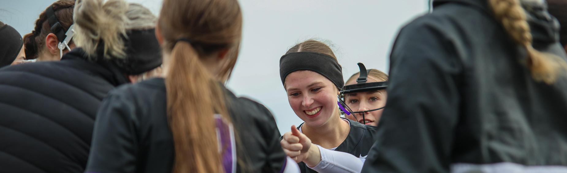 Softball players in hudle