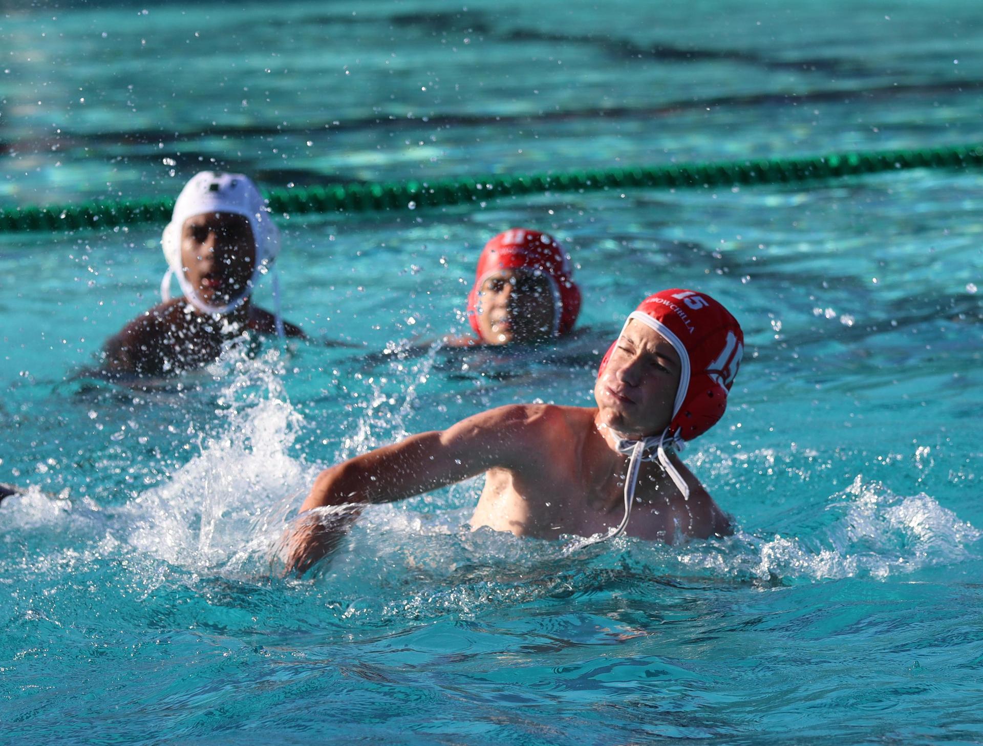 boys water polo players in action against hoover